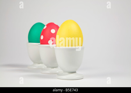 Colored Easter eggs in egg cups Stock Photo