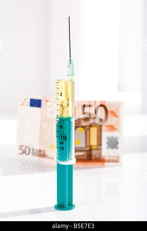 Syringe and Euro note, close-up Stock Photo