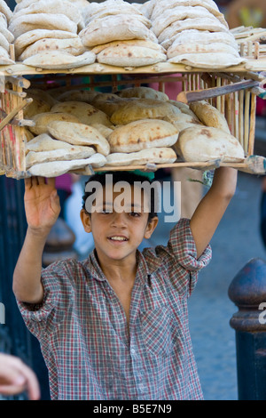 Boy Selling Fresh Bread on the Streets in Islamic Cairo Egypt Stock Photo