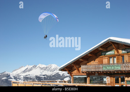 Parapente with skiers in blue sunny sky near chalet. St Gervais Haute Savoie France. Horizontal.  50425 Montblanc-Ski2005 Stock Photo