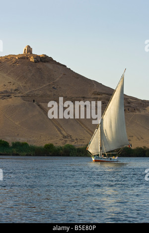 Tomb of Qubbet El Hawwa and Nobles Tombs with Felucca Sailboat on the Nile River in Aswan Egypt Stock Photo