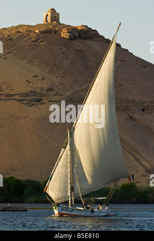 Tomb of Qubbet El Hawwa and Nobles Tombs with Felucca Sailboat on the Nile River in Aswan Egypt Stock Photo