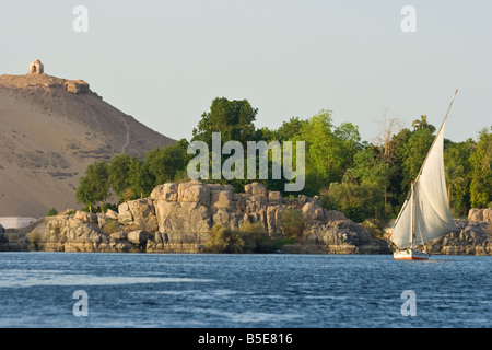 Tomb of Qubbet El Hawwa with Felucca Sailboat on the Nile River in Aswan Egypt Stock Photo