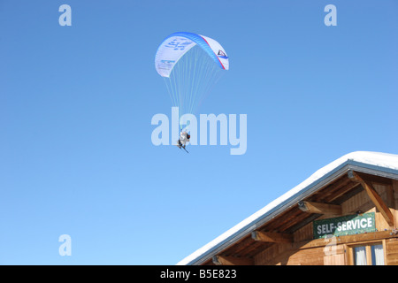 Parapente with skiers in blue sunny sky near chalet. St Gervais Haute Savoie France. Horizontal.  50424 Montblanc-Ski2005 Stock Photo