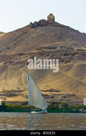 Tomb of Qubbet El Hawwa and Nobles Tombs with Felucca Sailboat on the Nile River in Aswan Egypt Stock Photo