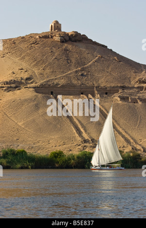 Tomb of Qubbet El Hawwa and Nobles Tombs with Felucca Sailboat on the Nile River in Aswan Egypt Stock Photo