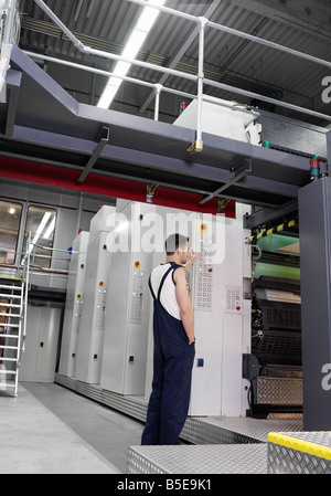 Worker standing in a printing office Stock Photo