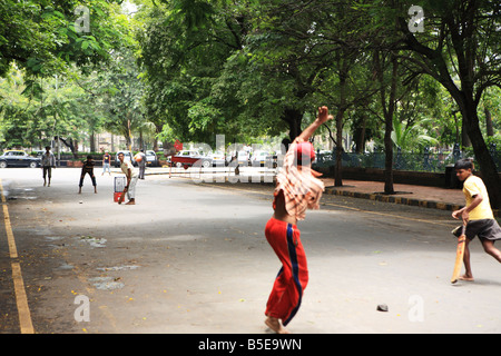 Boys playing street cricket Mumbai, India Stock Photo