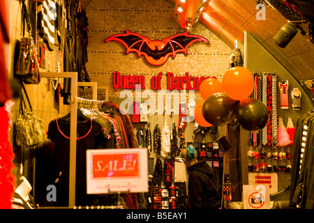 London , Camden Stables outdoor Market , The Queen of Darkness Clothes Boutique interior with young girl with green hair Stock Photo