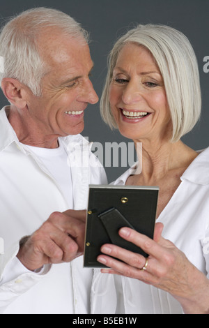 Senior couple looking at a picture Stock Photo