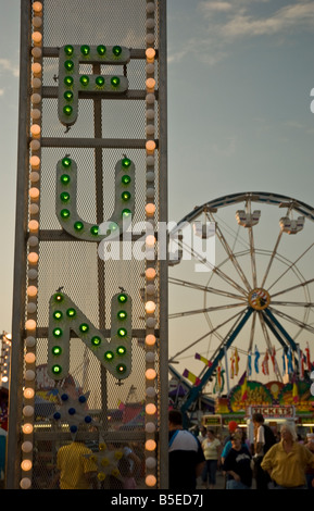 Fun Fair Rides Signage Fun Fair entrance sign on metal fencing behind waltzer lorry ...