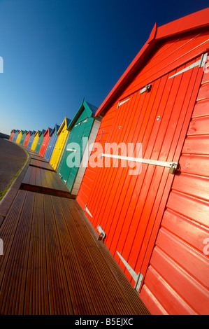 Bright multi coloured beach huts along Dawlish seafront at dawn Dawlish Devon UK Stock Photo