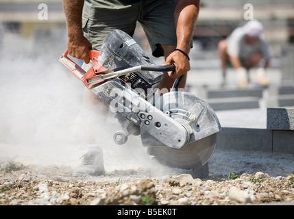 Construction worker using angle grinder Stock Photo