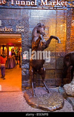 Camden Stables Market , Horse Tunnel Market rearing horses sculpture feature & no dogs allowed sign ! History of Stables on wall Stock Photo