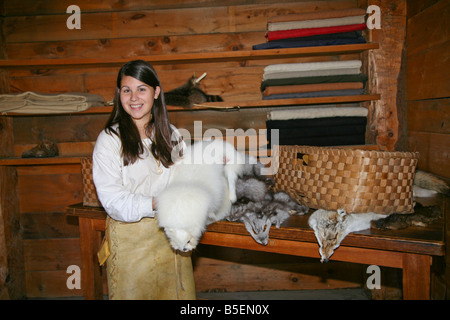 Native Indian Maiden with a collection of Furs at the authentic Indian Village Midland Ontario Canada Stock Photo