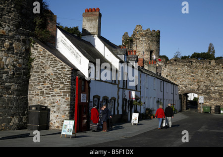 Local woman in Welsh National Costume outside Britain's smallest house in the north Wales seaside town of Conwy Stock Photo