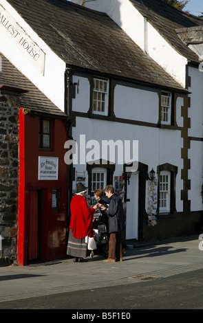 Local woman in Welsh National Costume outside Britain's smallest house in the north Wales seaside town of Conwy Stock Photo