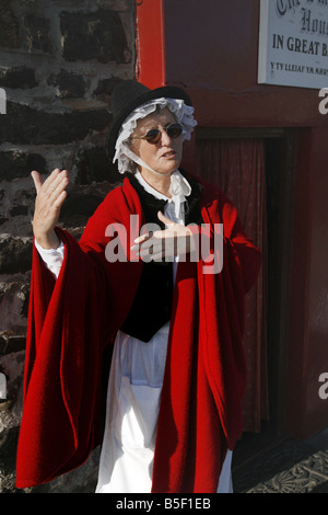 Local woman in Welsh National Costume outside Britain's smallest house in the north Wales seaside town of Conwy Stock Photo