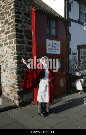 Local woman in Welsh National Costume outside Britain's smallest house in the north Wales seaside town of Conwy Stock Photo