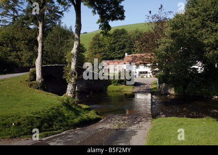 The pretty Exmoor hamlet of  Malmsmead on Badgworthy Water in the Doone Valley near Oare Stock Photo