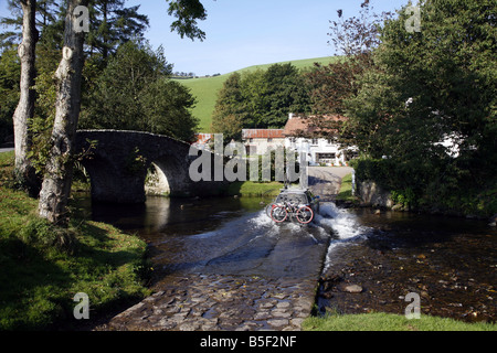 The pretty Exmoor hamlet of  Malmsmead on Badgworthy Water in the Doone Valley near Oare Stock Photo