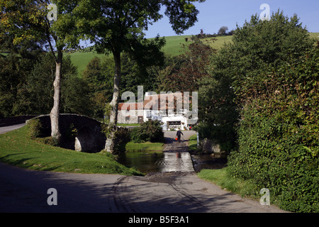 The pretty Exmoor hamlet of  Malmsmead on Badgworthy Water in the Doone Valley near Oare Stock Photo