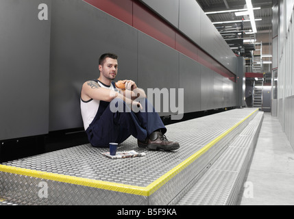 Worker sitting in printing company Stock Photo
