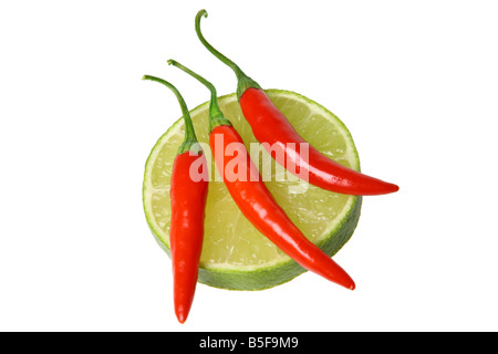 Red chili peppers and lime cutout on white background Stock Photo