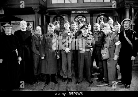 Stars of the popular wartime comedy television programme Dads Army toast pose for a group photograph after recording the final ever episode at BBC Television Centre in Shepherd s Bush July 1977 Stock Photo