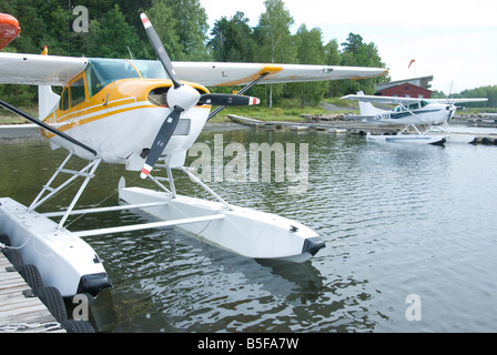 Two seaplanes a white and yellow Cessna 172 Skyhawk and a white Cessna 185 Skywagon Stock Photo