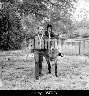 Sterling Moss (Ex Racing Driver). Seen here with horse and daughter. June 1974 S74-3861-002 Stock Photo