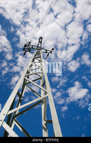 Electricity pylon with blue sky and small white clouds behind Stock ...
