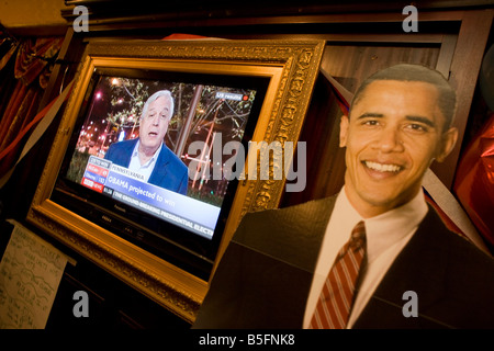 BBC News coverage shows John Simpson speaking behind a life size cardboard cut out of Barack Obama during 2008 elections Stock Photo