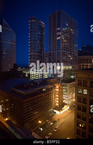 The famous Chicago Theatre Marquee glows against the downtown skyline Stock Photo