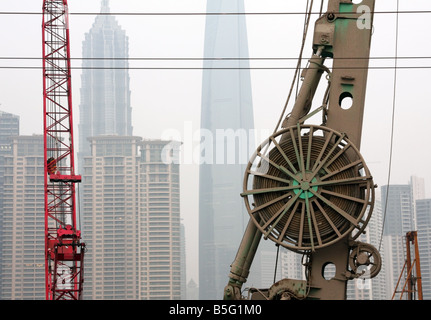 Construction equipment and modern buildings under smog sky in Shanghai China