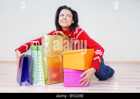 Glad lady indoors with gift shopping presents Stock Photo