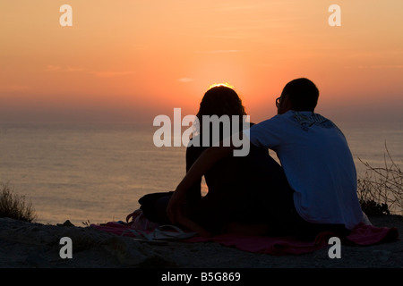 Couple watching the sunset over the Atlantic Ocean at Saint Jean de Luz southwest France Stock Photo