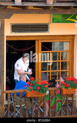 People dine on the balcony of a restaurant in the town of Potes Liebana Cantabria northwestern Spain Stock Photo