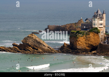 Surfing Cote de Basque below a castle in the Bay of Biscay at the town of Biarritz southwest France Stock Photo