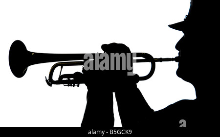 A servicemember plays Taps during a ceremony. Stock Photo