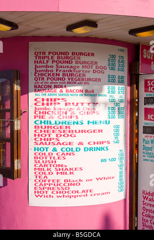 Price list at hot and cold food,and drink take away kiosk selling chips burgers and hot dogs etc. Stock Photo