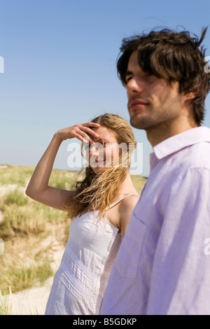 Germany, Baltic sea, Young couple in sand dunes, portrait