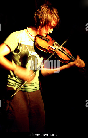 Violinist in a band playing live on stage Stock Photo