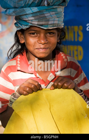 Indian street girl carry rice pot wrapped in cloth on her head. Andhra Pradesh, India Stock Photo