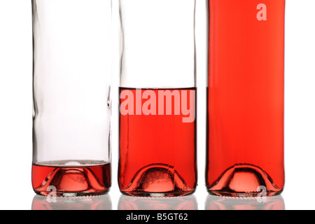 bottles of rose wine at variations of fullness empty half and full Stock Photo