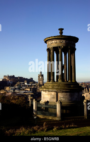 Dugald Stewart monument on Calton Hill in the foreground with  Edinburgh Castle in the distance, Scotland, UK, Stock Photo