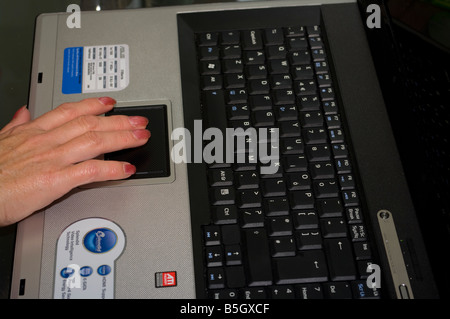 Womans Person fingers Hand Using The Touchpad of a Laptop Computer Stock Photo