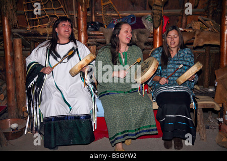 Three Native women singing in long-house at Huron-Jesuit Aboriginal Indian Village near Midland Ontario Canada Stock Photo