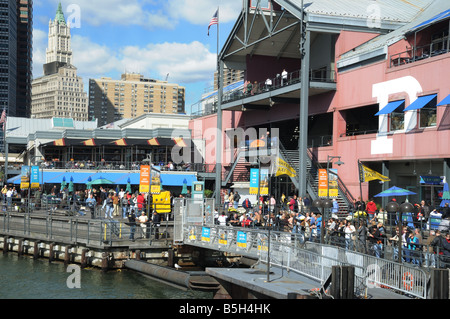 The South Street Seaport in Lower Manhattan. In the background is the Woolworth Building once the tallest building in the world. Stock Photo