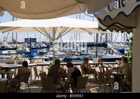 dh Marina PUERTO CALERO LANZAROTE Tourist Holidaymaker relaxing in outdoor marina cafe Stock Photo